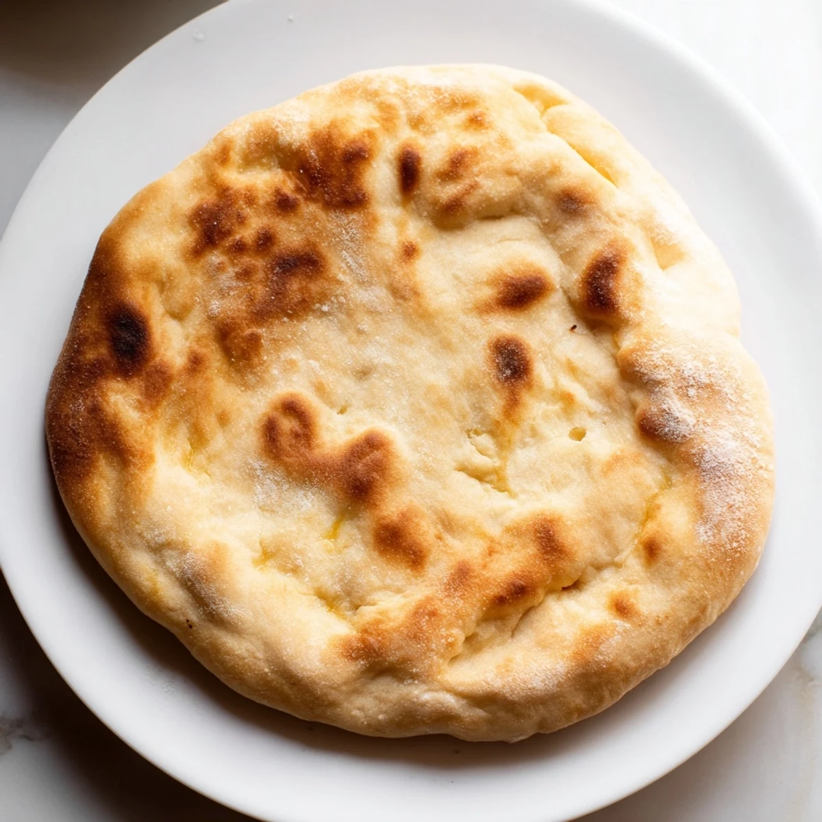 Golden-brown Three-Ingredient Easy Flatbreads, ready to be torn and dipped into savory spreads.