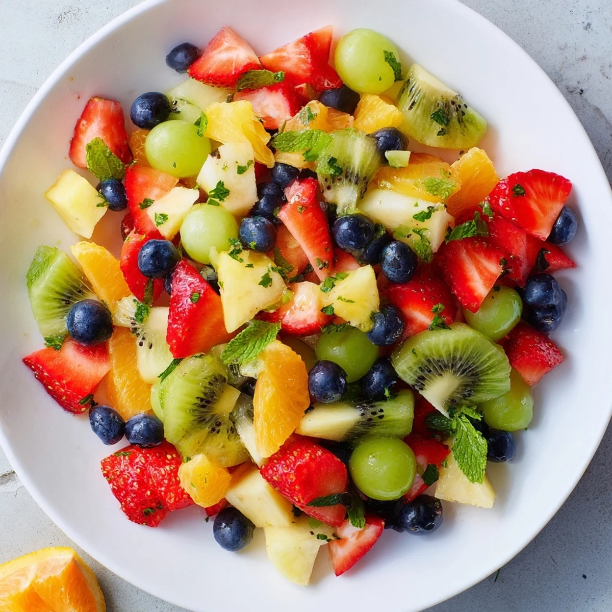 Juicy close-up: This refreshing fruit salad with honey-lime dressing is piled high, ready to serve and enjoy.