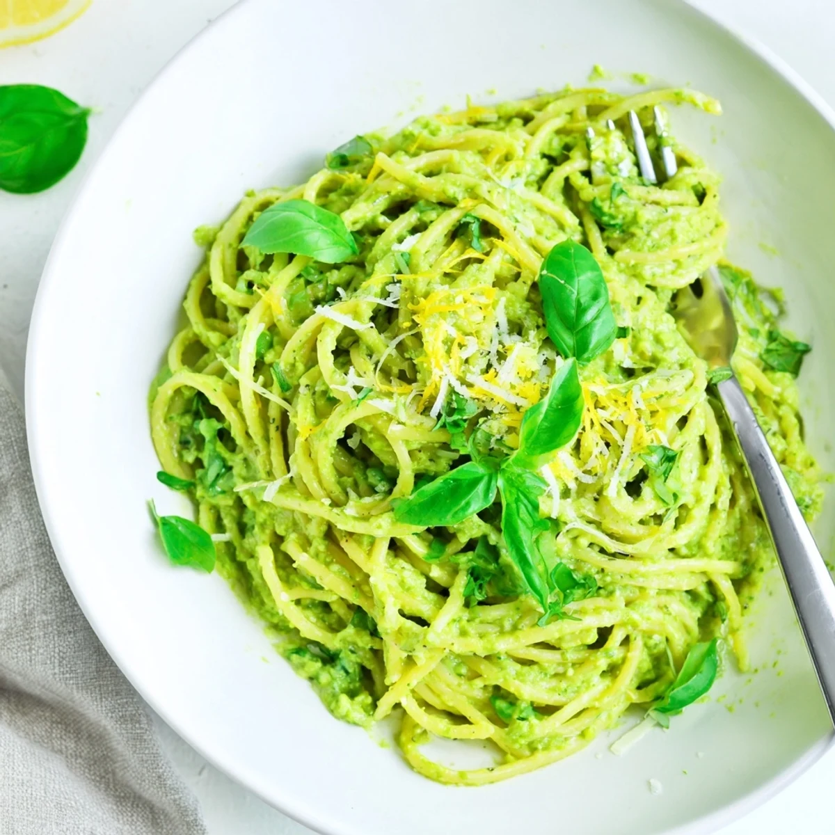 A close-up shot of Creamy Avocado Pasta with a sprinkle of Parmesan, smelling fresh and zesty.