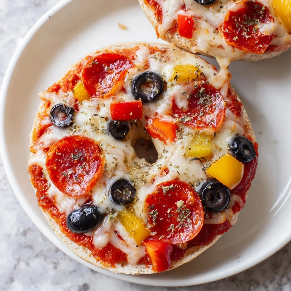 Golden, bubbly mini bagel pizzas fresh from the air fryer, a perfect snack or appetizer.