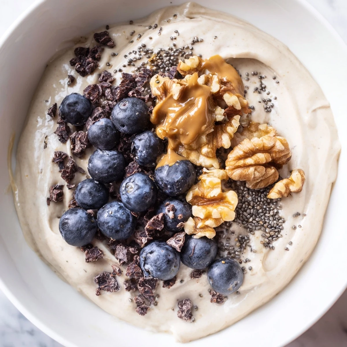 Creamy Protein Ice Cream Bowl, swirled with fresh berries, offers a refreshing, healthy treat idea.