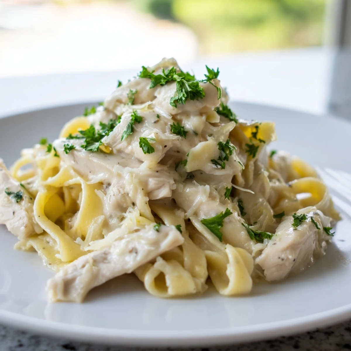 Golden Skillet Chicken Alfredo features tender chicken and fettuccine coated in a rich, creamy Parmesan sauce.