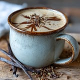 Whisked hojicha powder blended with creamy oat milk and vanilla, poured into a rustic ceramic mug.