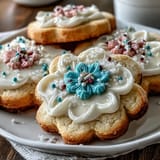 Buttery flower-shaped shortbread cookies decorated with colorful royal icing, offering a sweet and elegant treat for any occasion.