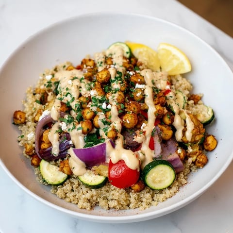 Vibrant Mediterranean Chickpea and Veggie Grain Bowl featuring colorful roasted vegetables and creamy tahini dressing.