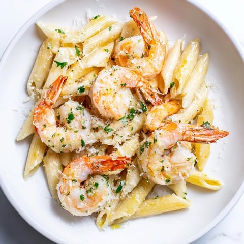 Golden Garlic Shrimp Penne, tossed with Parmesan and parsley, ready to be served.