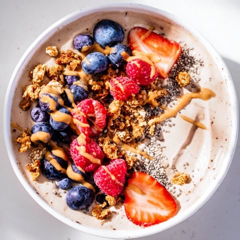 A layered Protein Ice Cream Bowl with fresh berries, offering a cool, healthy treat.