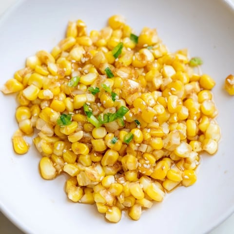 Golden Japanese Butter Corn kernels sizzling in a skillet, ready to be served hot.
