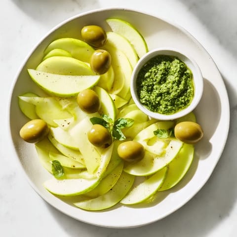 A close-up of The Emerald City appetizer spread, showcasing green olives and zesty lime slices.