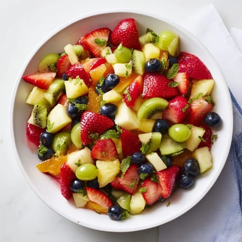 Vibrant image of refreshing fruit salad featuring strawberries, blueberries, and grapes, perfectly chilled for dessert.