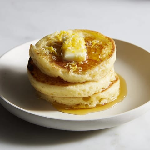 A close-up of light and fluffy ricotta pancakes, showcasing their airy texture and delightful golden crust.