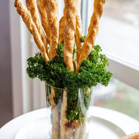 The Vertical Forest: Tall breadsticks stand like trees encircled by grapes and fresh parsley.