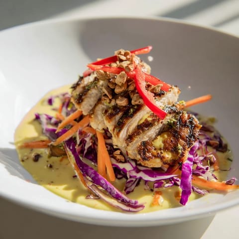Perfectly cooked chicken and fresh carrot ribbons are featured in this light and healthy Asian-inspired Carrot Ribbon and Chicken Slaw.
