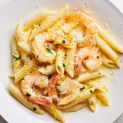 A close-up of steaming Garlic Shrimp Penne, a delicious Italian-American main dish.