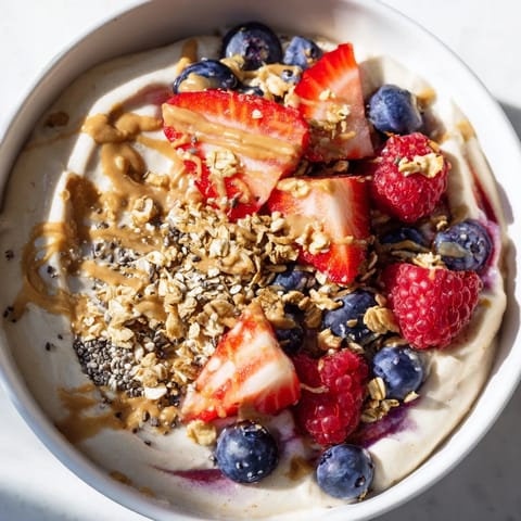 This creamy and delicious Protein Ice Cream Bowl is topped with granola and chia seeds.