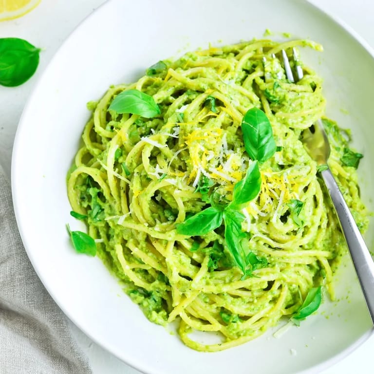 A close-up shot of Creamy Avocado Pasta with a sprinkle of Parmesan, smelling fresh and zesty.