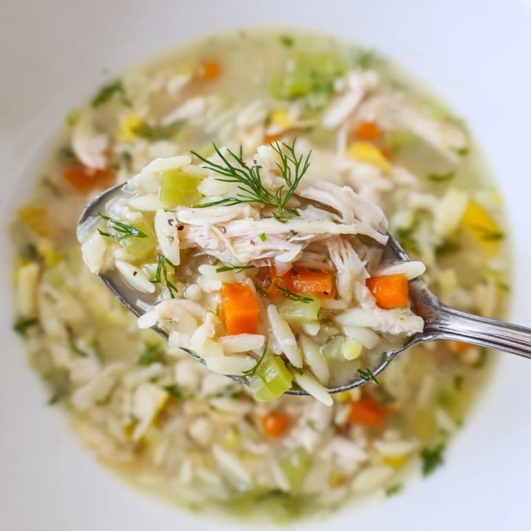 Bright and comforting Chicken Lemon Orzo Soup, featuring juicy chicken, zesty lemon, and fresh herbs, perfect for a cozy lunch.
