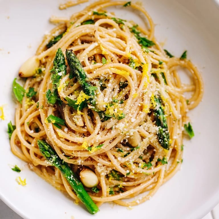 Ready-to-serve Roasted Garlic & Asparagus Pasta, garnished with fresh parsley and extra grated Parmesan, looks rustic and inviting.