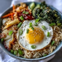 Vibrant Fermented Cabbage Kimchi Fried Rice with a sunny-side-up egg.
